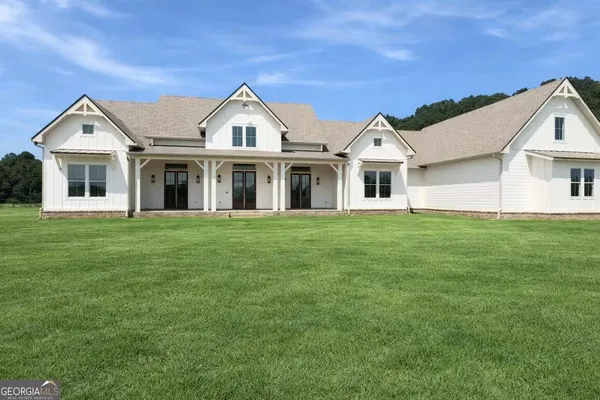 a front view of a house with a garden and porch