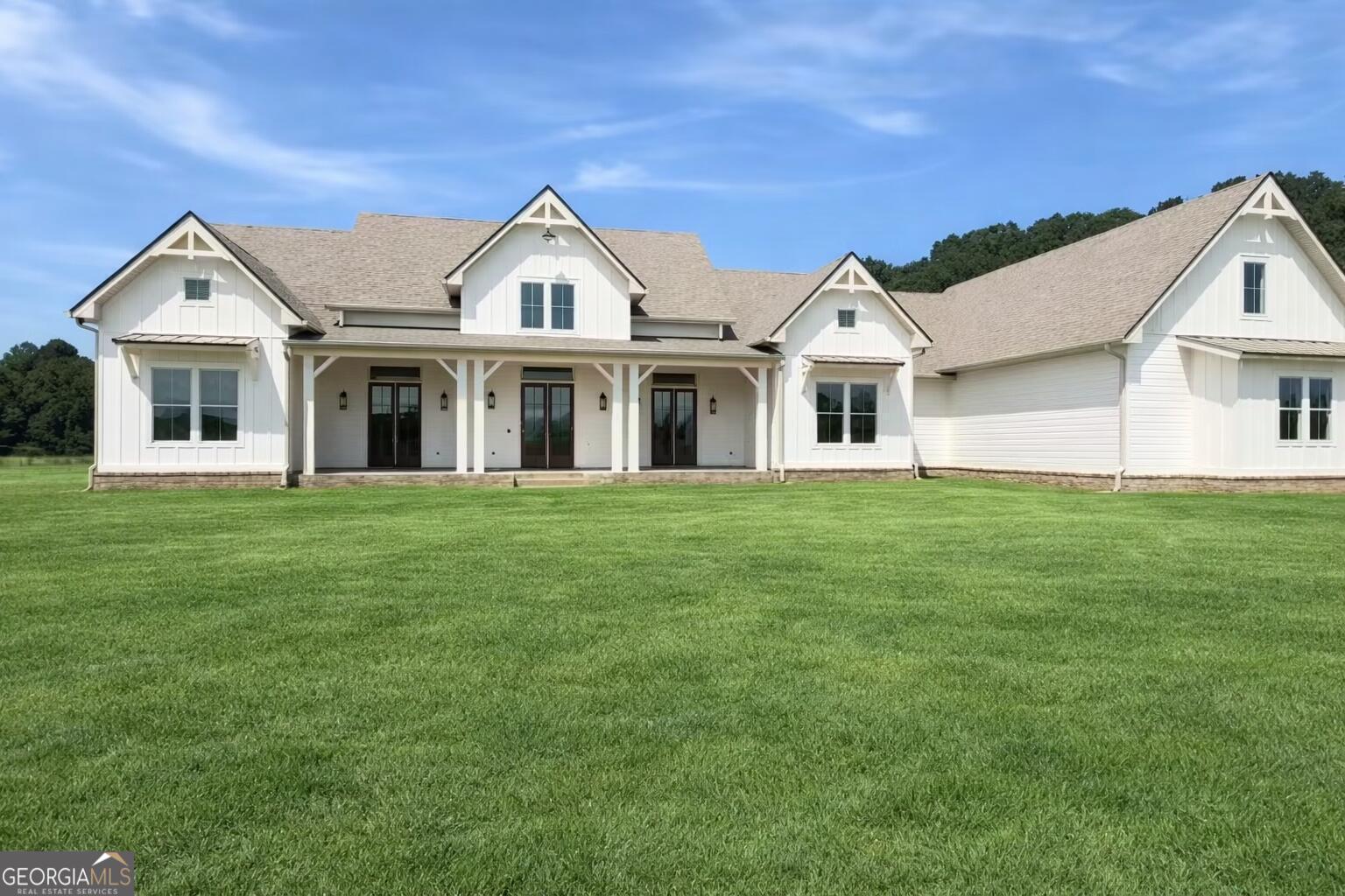 a front view of a house with a garden and porch