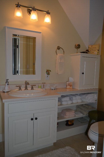 8919 Red Fish Pt Road Lillian, AL 36549 - Photo 26 of 46 Full size guest bath with built-ins and tub/shower combination.