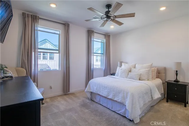 a bedroom with a large bed and a chandelier