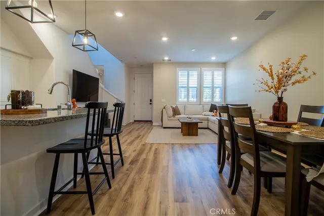 a view of a dining room with furniture window and wooden floor