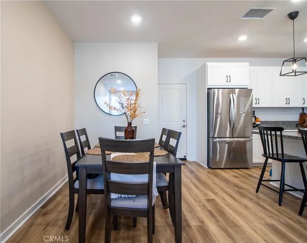 a dining room with furniture and a chandelier