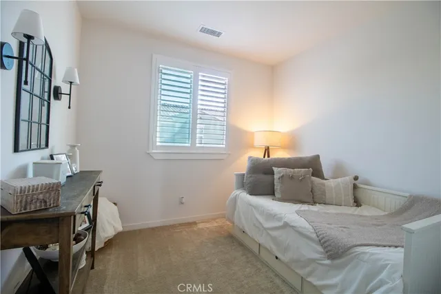 a bedroom with a bed and a table