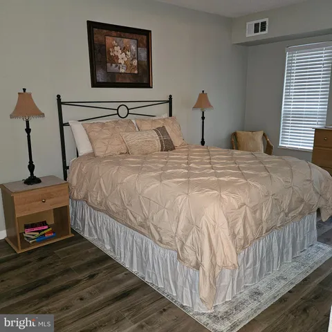 a bedroom with bed and a window