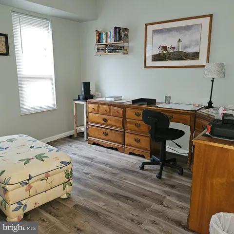 a bedroom with a bed and a desk