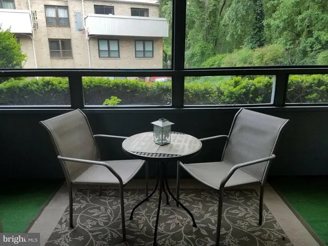 a balcony view with a seating space