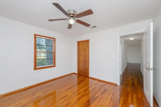 a view of an empty room with a window and closet