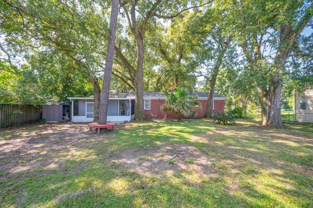 a backyard of a house with lots of green space and fountain