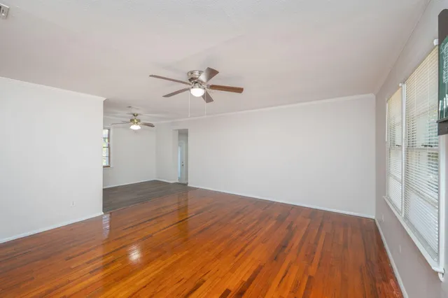 wooden floor in an empty room with a window