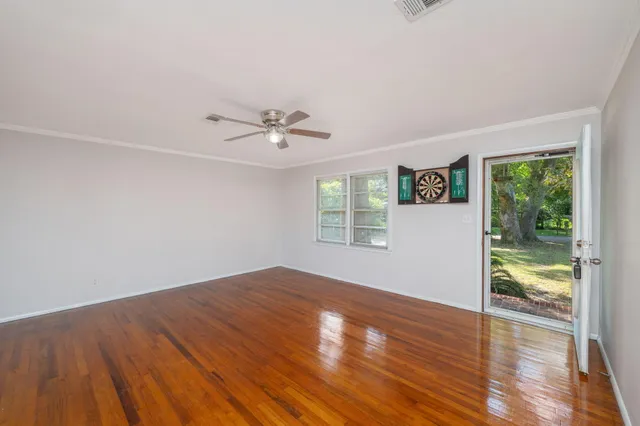 wooden floor in an empty room with a window