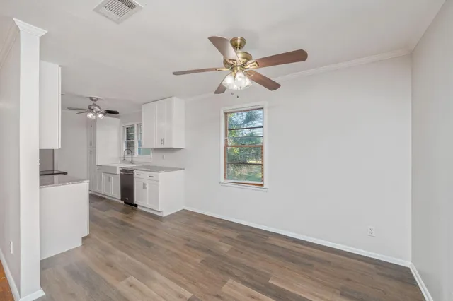 a kitchen with a refrigerator and white cabinets