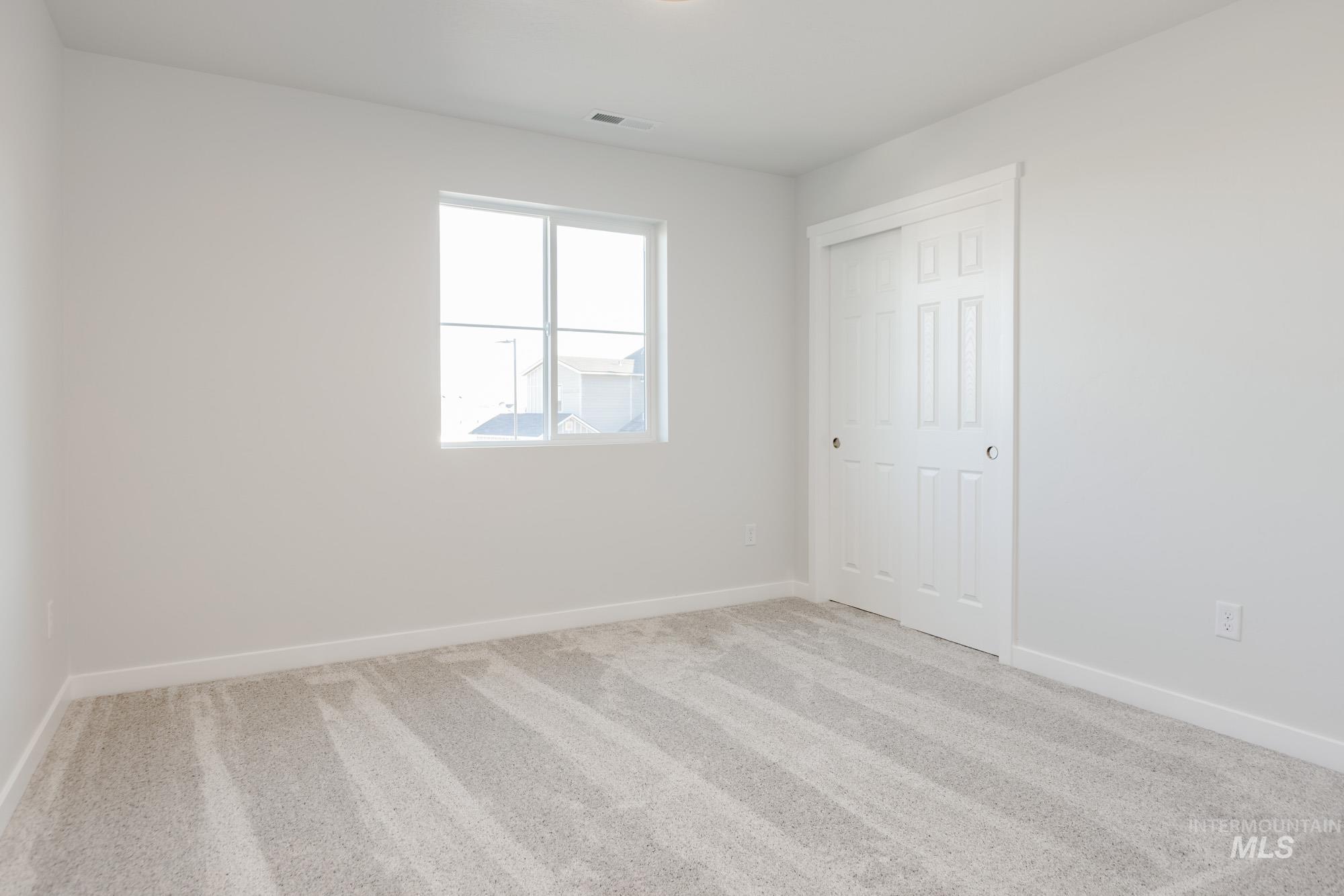 1639 Celina Street Middleton, ID 83644 - Photo 16 of 19 Neutral-toned carpeting spans the room, complemented by white walls and trim