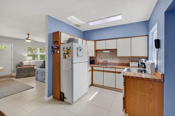 a kitchen with a refrigerator a stove top oven a sink and dishwasher