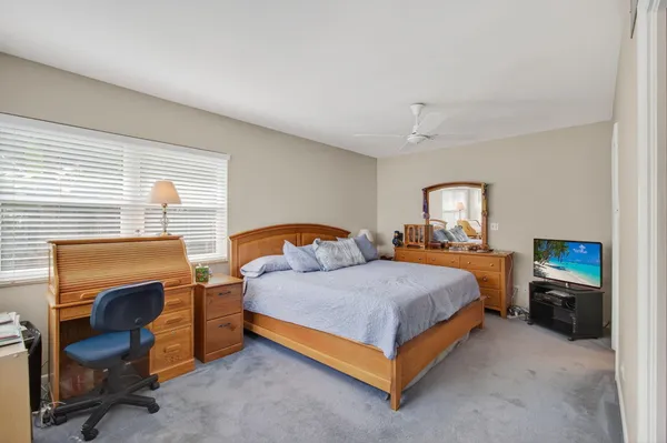 a bed room with a bed and a chair
