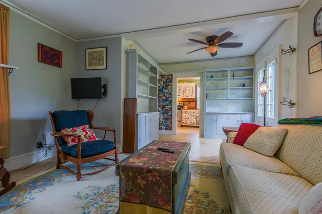 a living room with furniture a rug and a wall painting