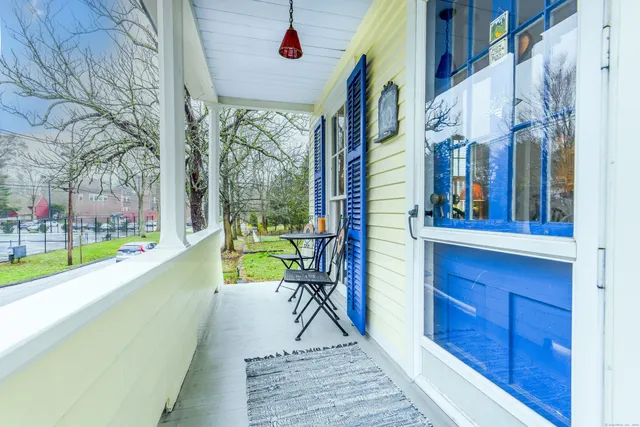 a view of a dining room with furniture and a potted plant