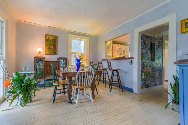 a dining room with furniture and wooden floor