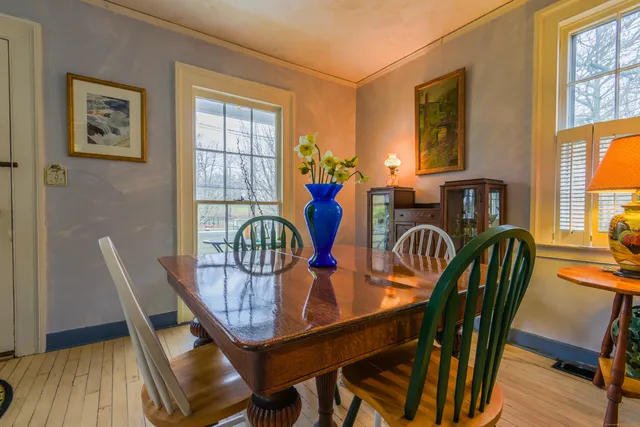 a view of a room with furniture and wooden floor