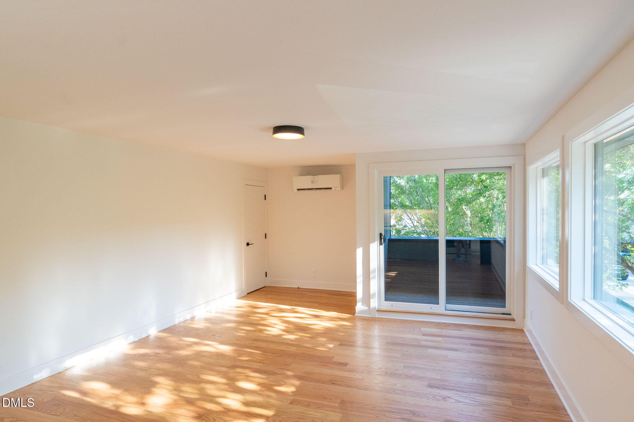 402 East Martin Street Raleigh, NC 27601 - Photo 6 of 23 an empty room with wooden floor and windows