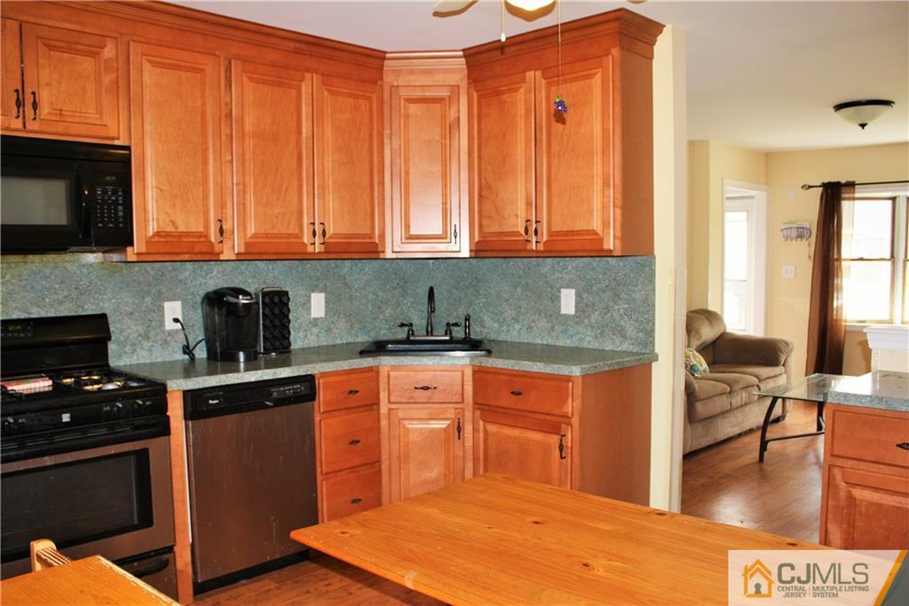 33 Ashley Road Edison, NJ 08817 - Photo 12 of 20 a kitchen with stainless steel appliances granite countertop a stove top oven a sink dishwasher and cabinets with wooden floor