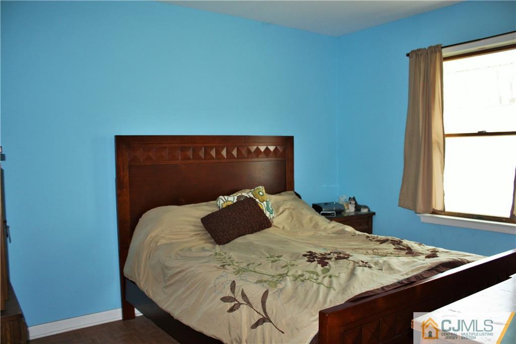 33 Ashley Road Edison, NJ 08817 - Photo 13 of 20 a bed sitting in a bedroom next to a window