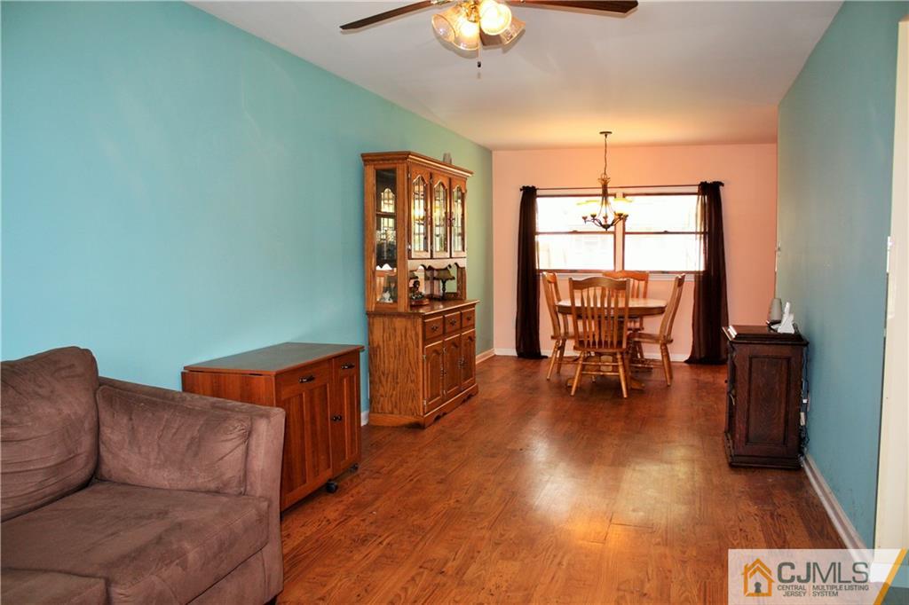33 Ashley Road Edison, NJ 08817 - Photo 8 of 20 a living room with furniture and a chandelier