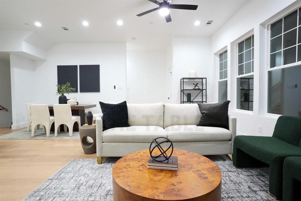 629 North Tyler Street, Unit 102 Dallas, TX 75208 - Photo 1 of 1 a living room with furniture and a flat screen tv