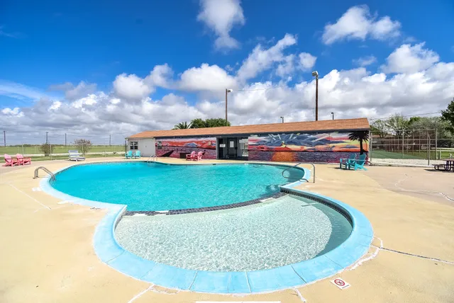a view of a park with iron fence