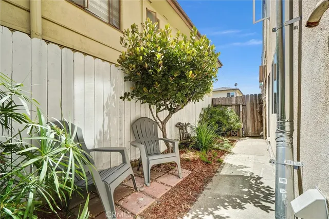 a view of a chair and table in backyard