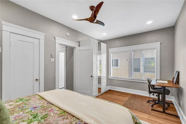 a bedroom with a bed a table and a window