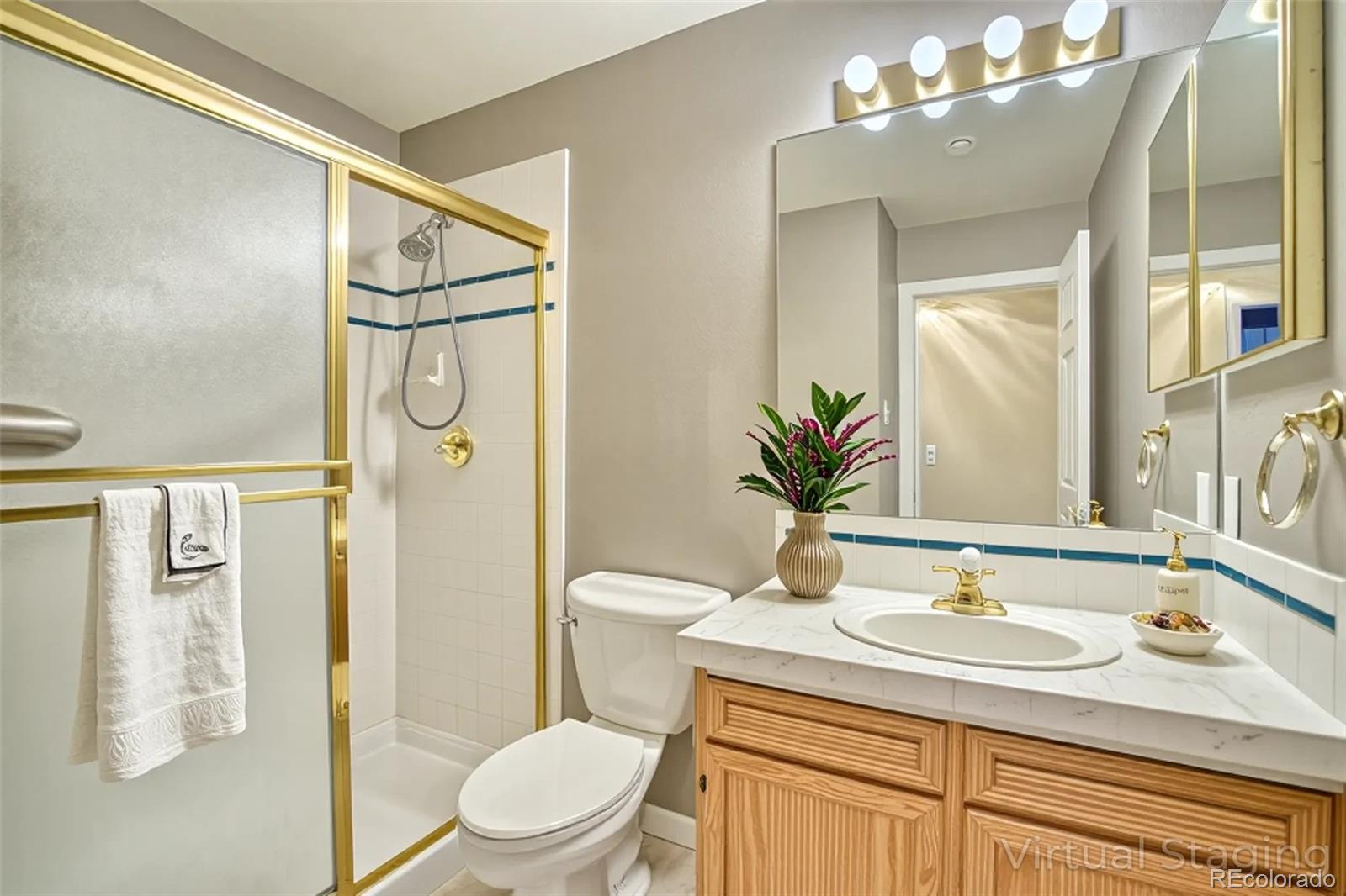 756 Brookside Drive Longmont, CO 80504 - Photo 31 of 46 a bathroom with a sink toilet and shower