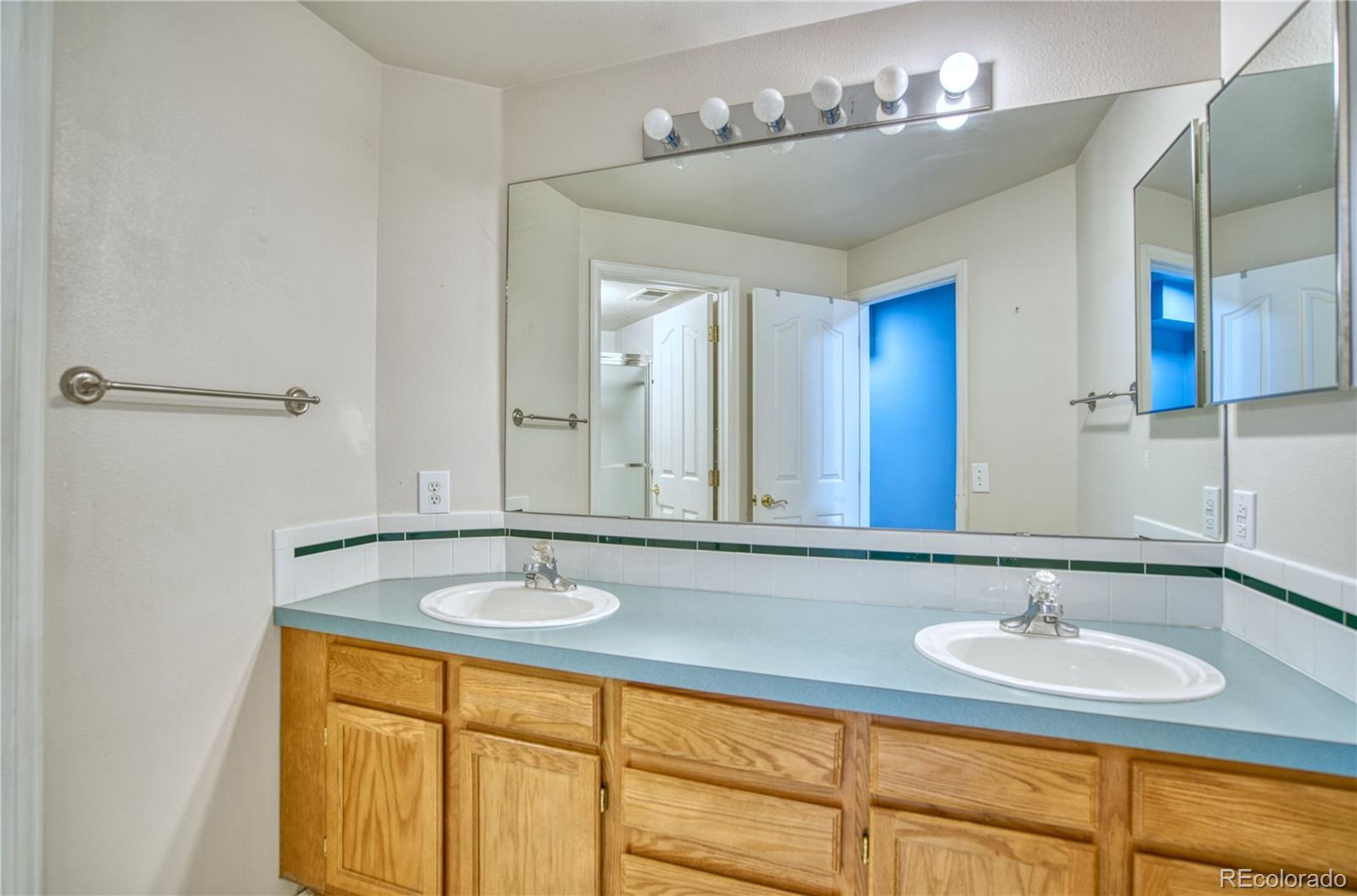756 Brookside Drive Longmont, CO 80504 - Photo 38 of 46 a bathroom with a sink and a mirror