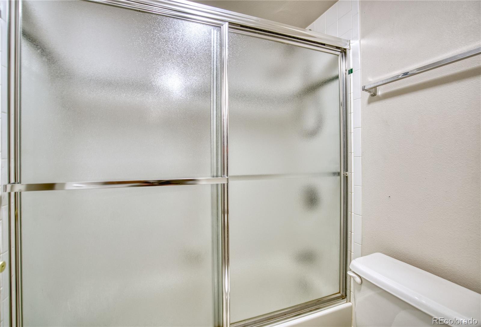 756 Brookside Drive Longmont, CO 80504 - Photo 40 of 46 a bathroom with a glass shower door