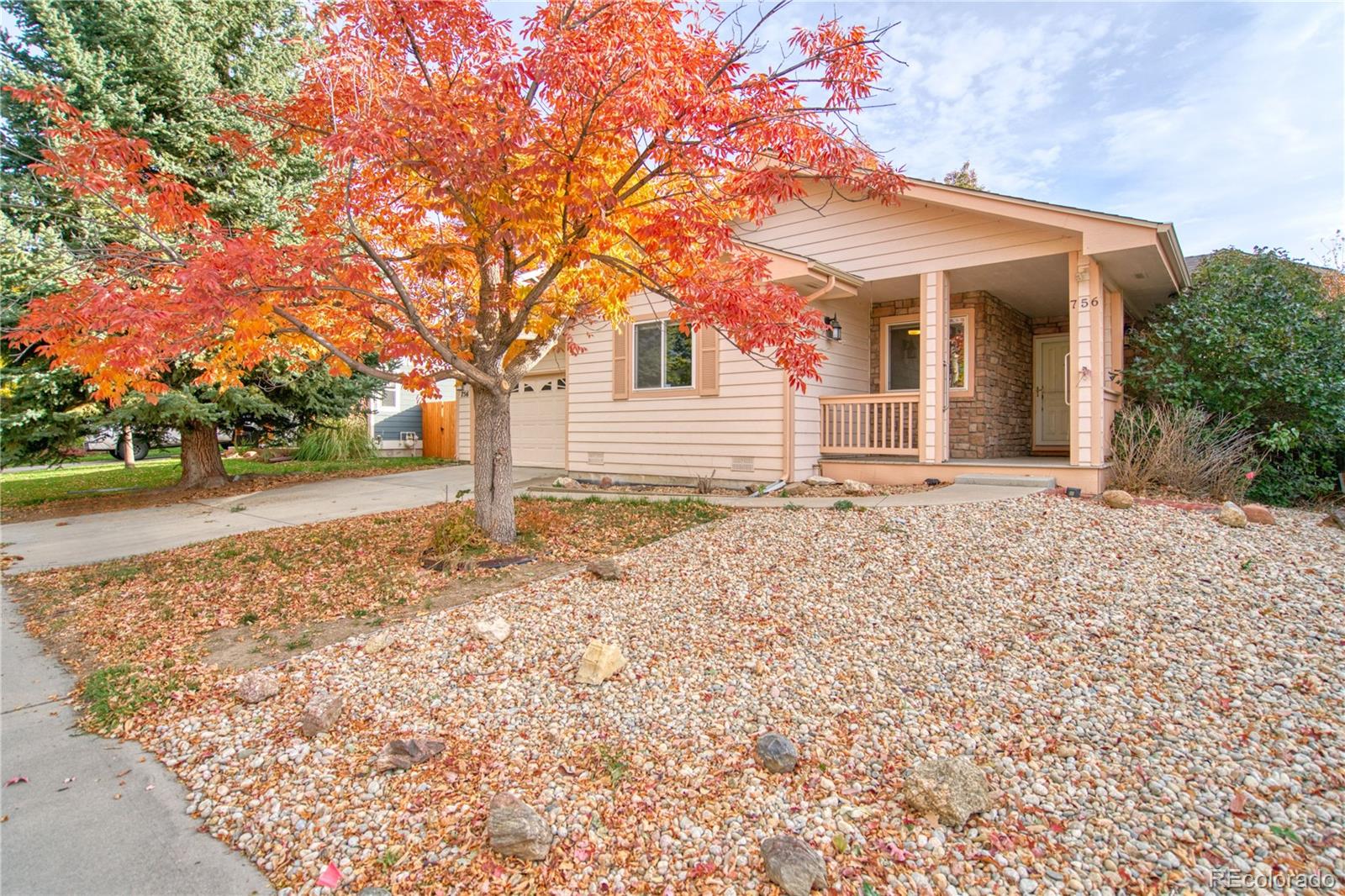 756 Brookside Drive Longmont, CO 80504 - Photo 4 of 46 a front view of a house with a yard