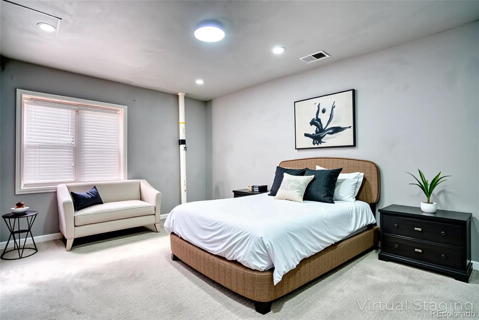 756 Brookside Drive Longmont, CO 80504 - Photo 42 of 46 a bedroom with a bed a couch and a couch