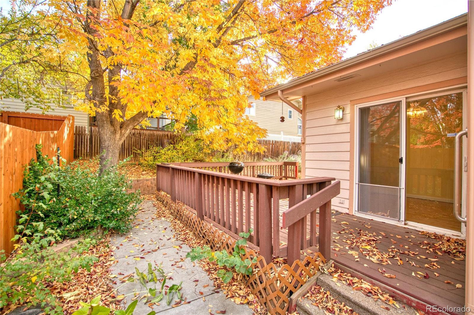 756 Brookside Drive Longmont, CO 80504 - Photo 43 of 46 a view of a porch with wooden floor and fence