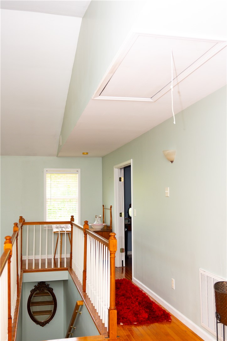 608 McKinney Way Westminster, SC 29693 - Photo 15 of 34 A classic wooden banister frames this sun-kissed landing, leading to private living spaces.