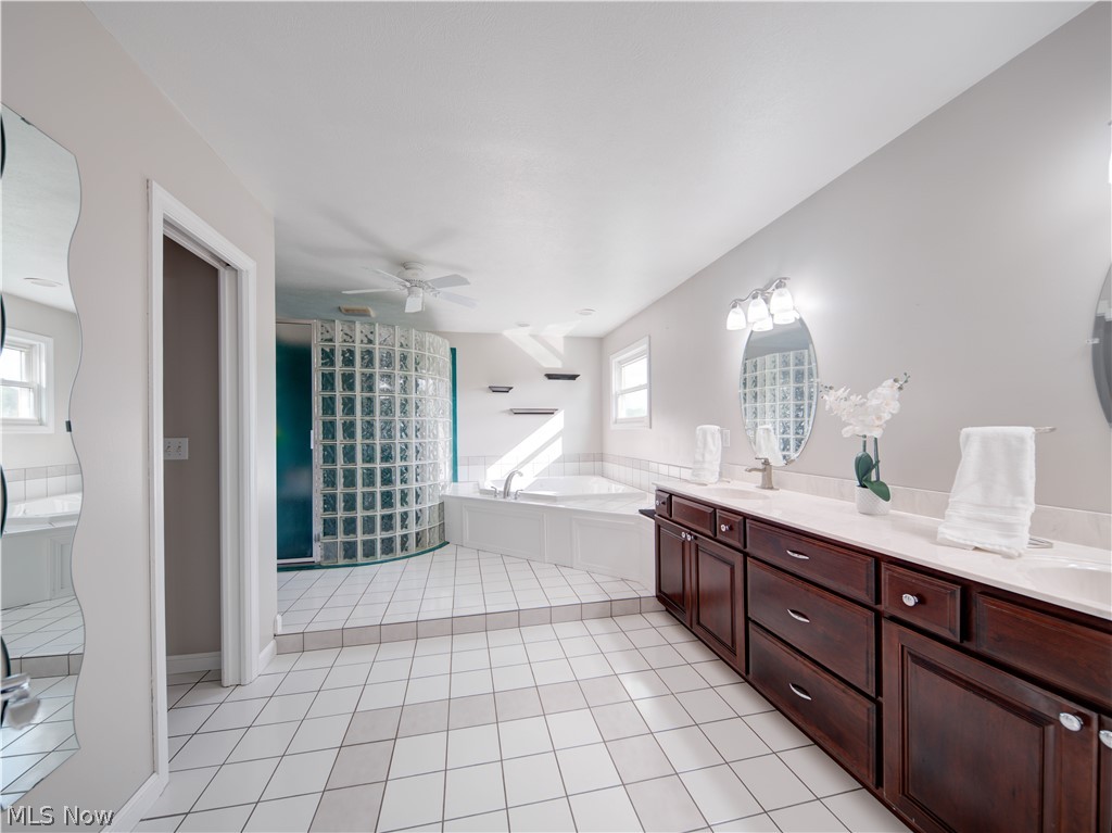9900 Mentor Road Chardon, OH 44024 - Photo 40 of 49 Bathroom featuring tiled bath, plenty of natural light, ceiling fan, and tile flooring