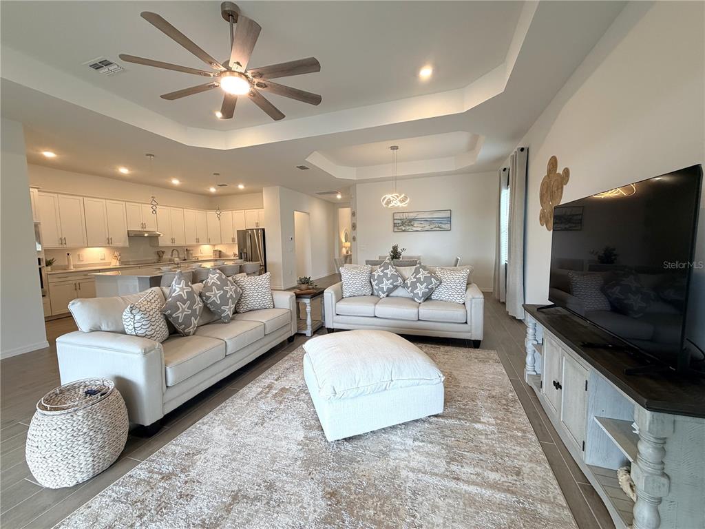 13081 Tulum Loop Venice, FL 34293 - Photo 13 of 48 a living room with furniture and a flat screen tv