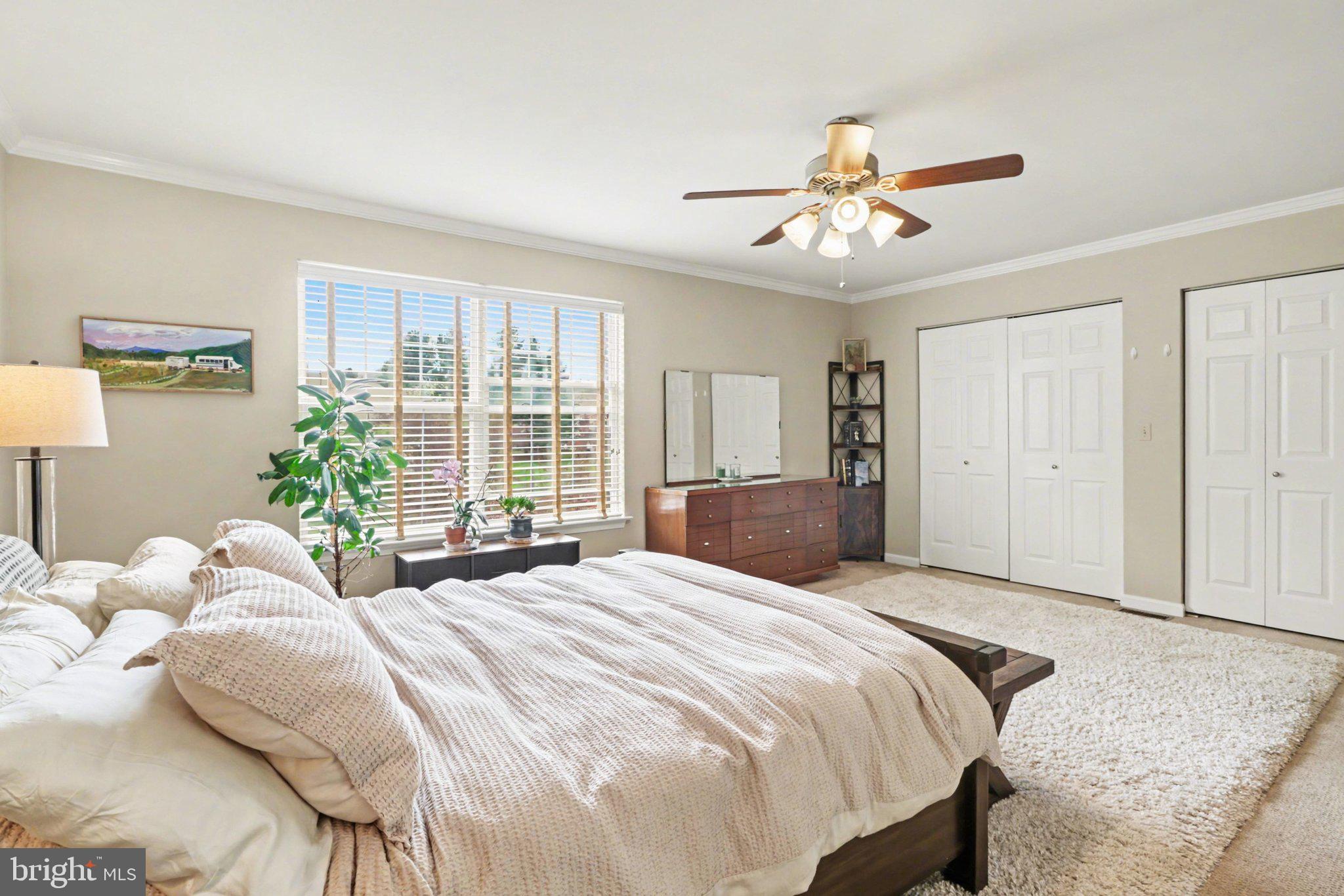 652 Springhouse Lane Hummelstown, PA 17036 - Photo 12 of 35 a bedroom with a large bed and a chandelier fan