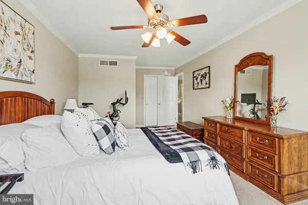 a bedroom with bed and wooden floor
