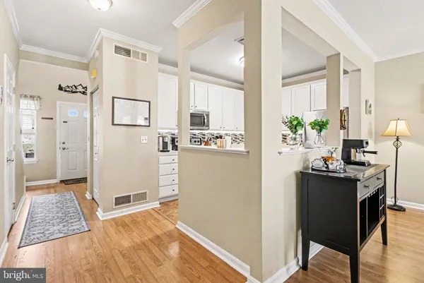 a view of kitchen with furniture and refrigerator