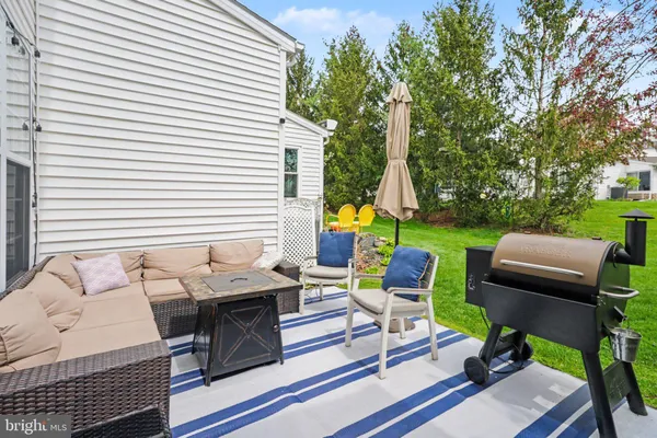 a view of a patio with table and chairs and potted plants