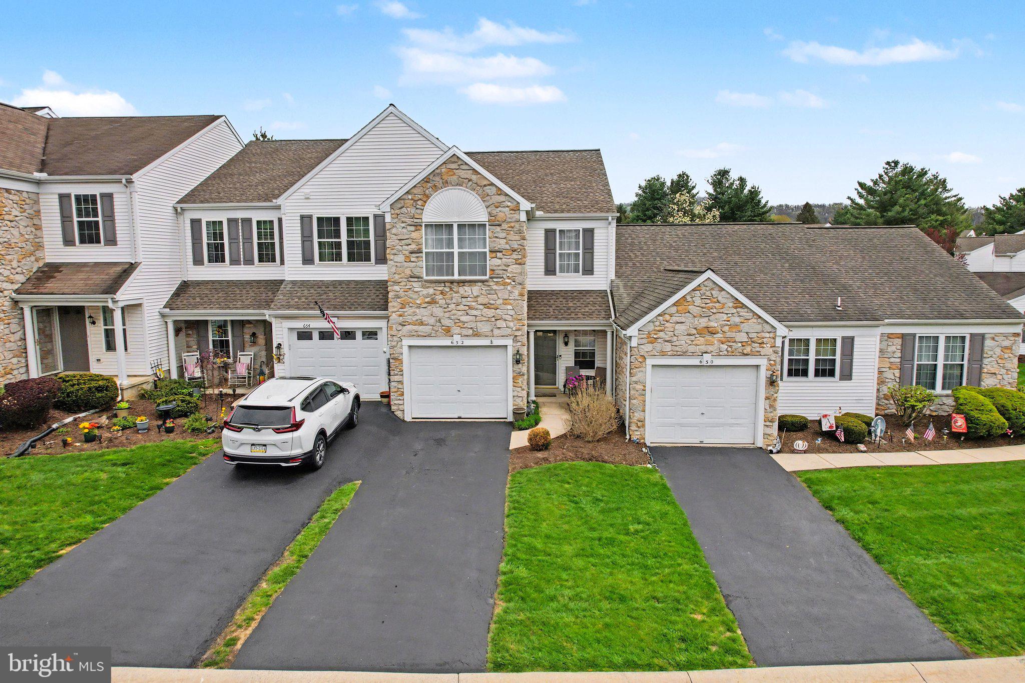 652 Springhouse Lane Hummelstown, PA 17036 - Photo 28 of 35 a front view of a house with a garden and trees