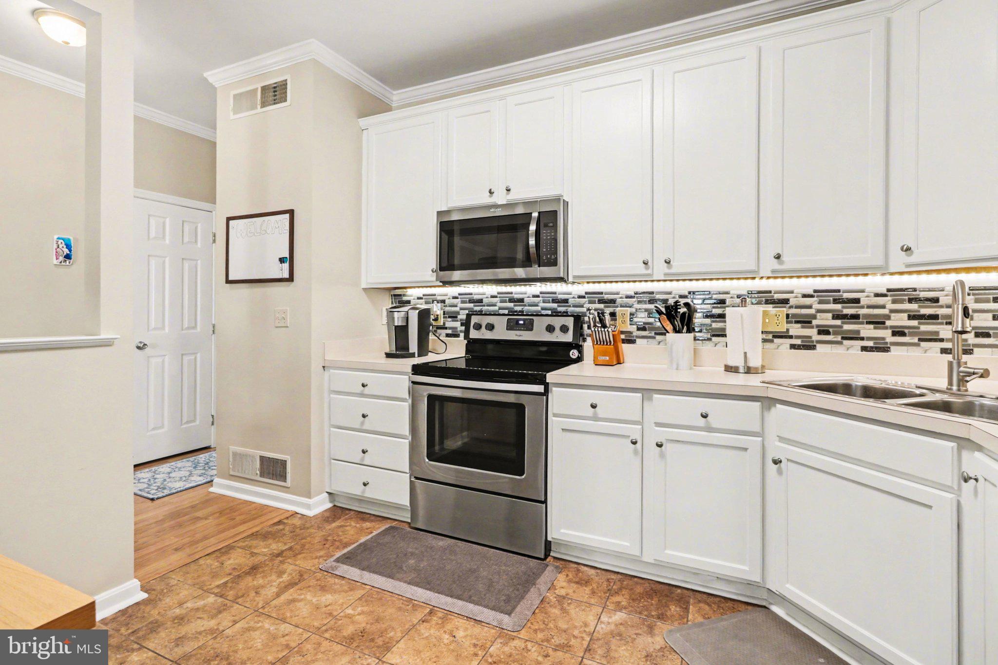 652 Springhouse Lane Hummelstown, PA 17036 - Photo 4 of 35 a kitchen with white cabinets and stainless steel appliances