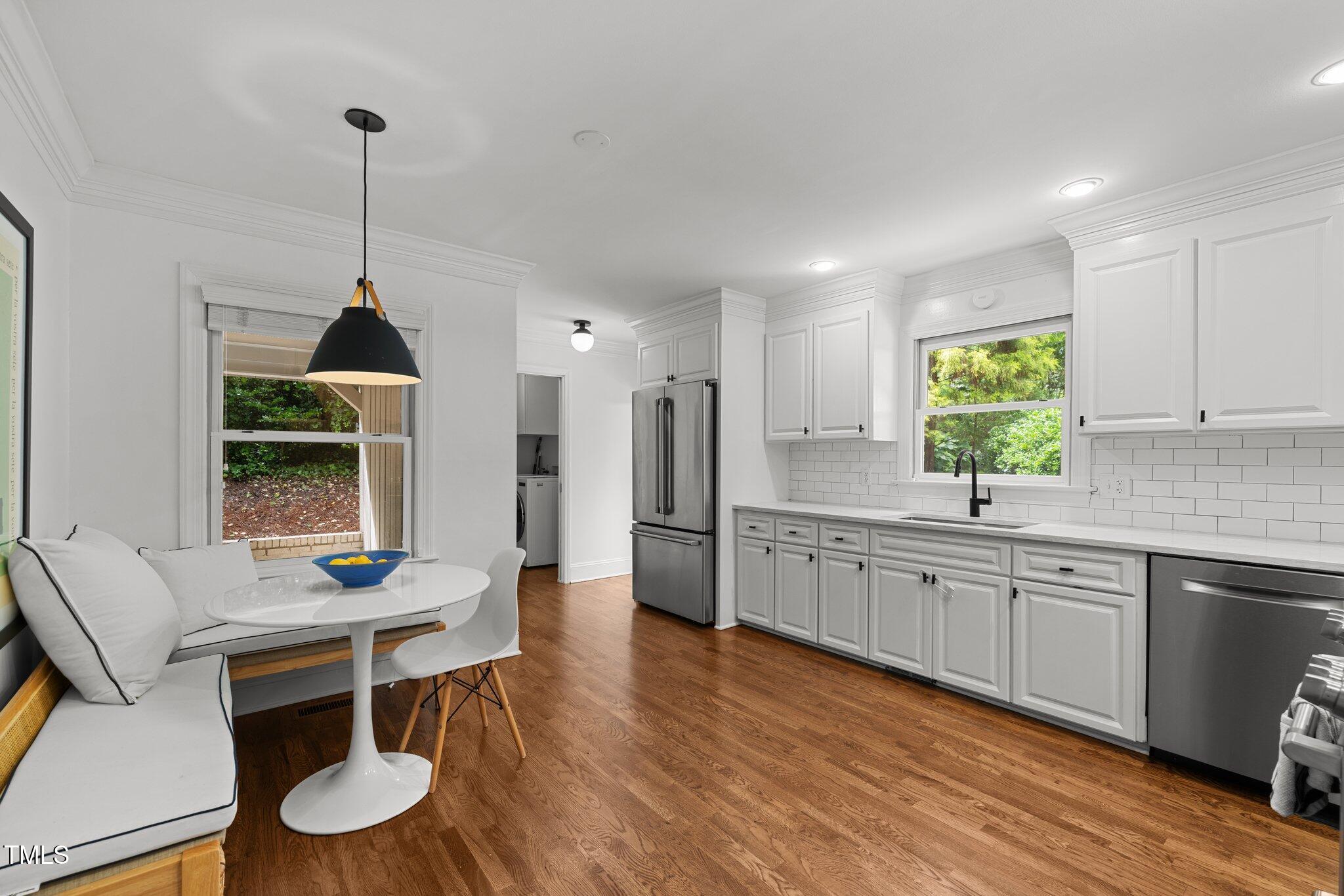 1706 Rangecrest Road Raleigh, NC 27612 - Photo 11 of 43 a kitchen with granite countertop white cabinets and stainless steel appliances