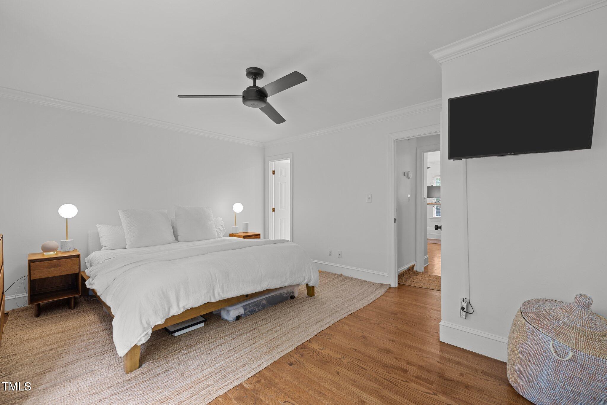 1706 Rangecrest Road Raleigh, NC 27612 - Photo 18 of 43 a spacious bedroom with a bed and a flat screen tv