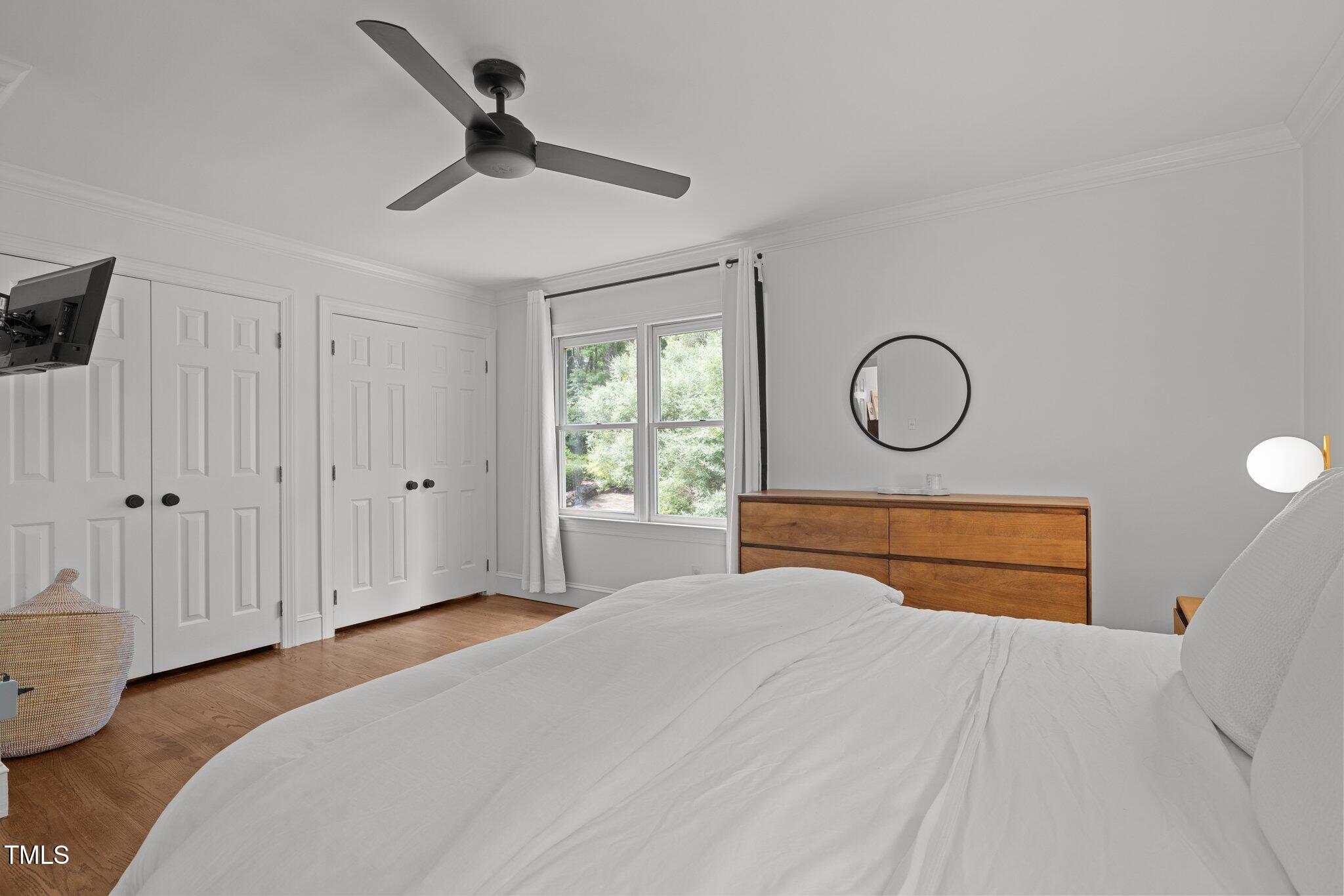 1706 Rangecrest Road Raleigh, NC 27612 - Photo 19 of 43 a bedroom with a bed and a chandelier