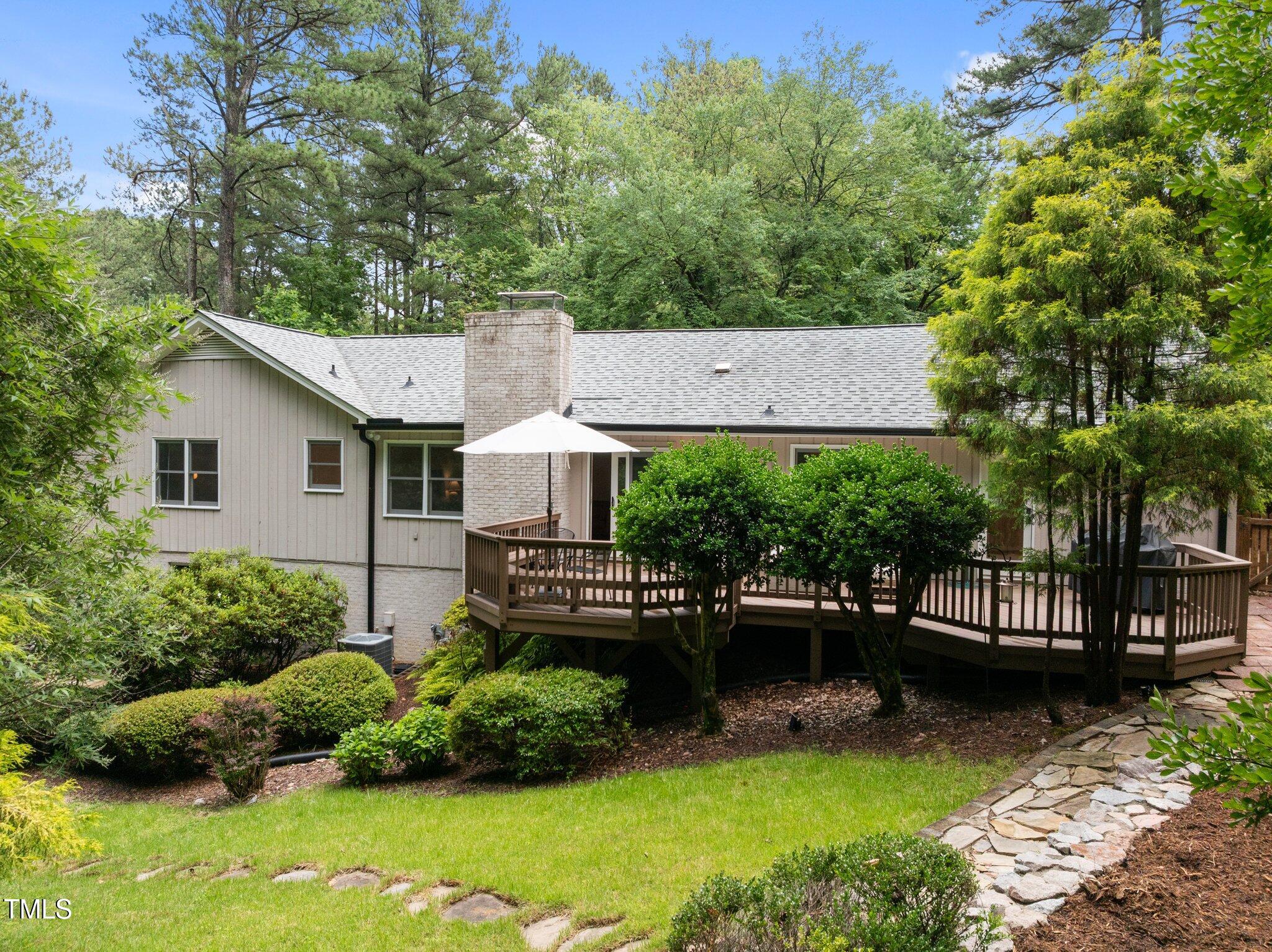1706 Rangecrest Road Raleigh, NC 27612 - Photo 2 of 43 a view of a chair and table in the backyard