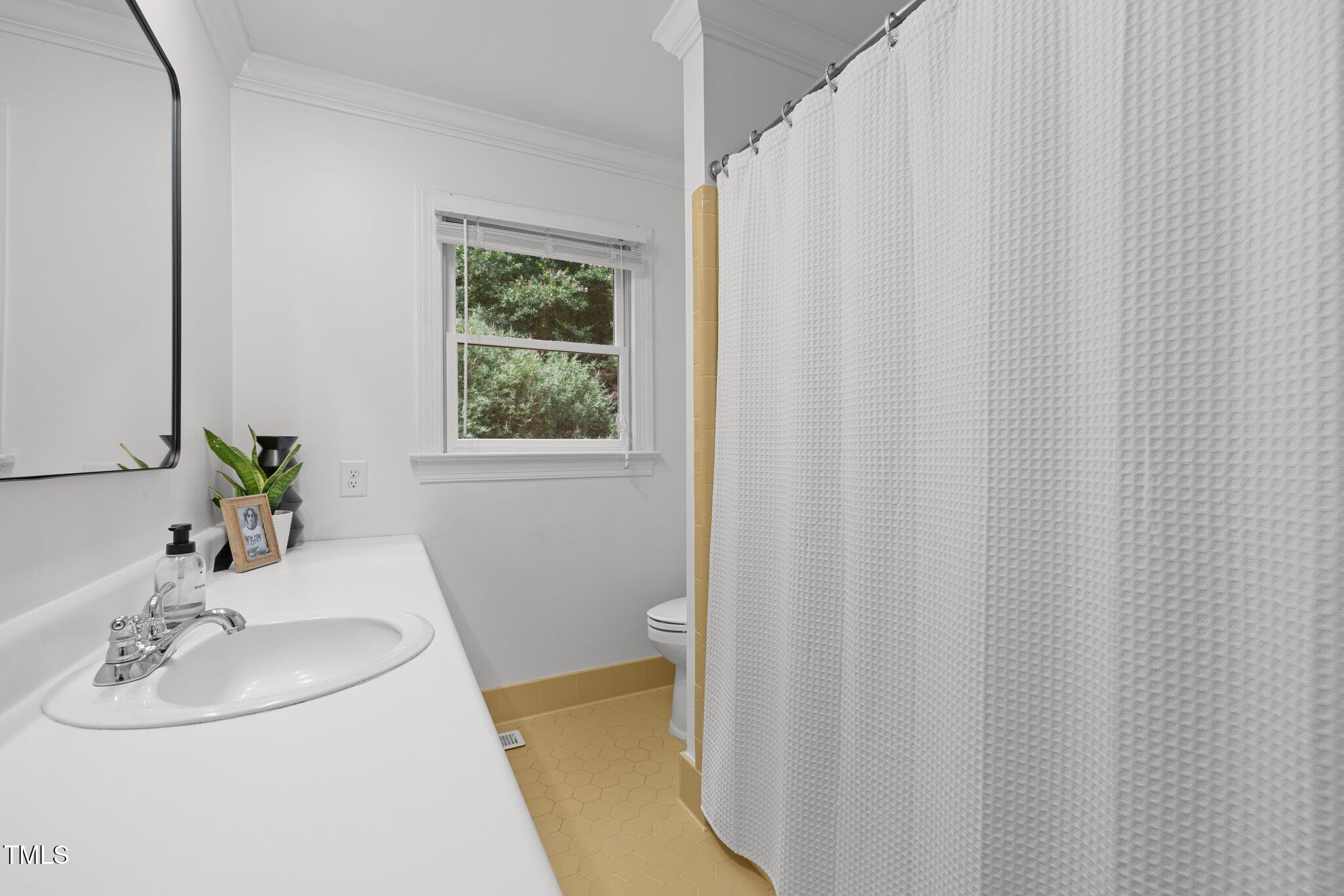 1706 Rangecrest Road Raleigh, NC 27612 - Photo 22 of 43 a bathroom with a sink and a mirror